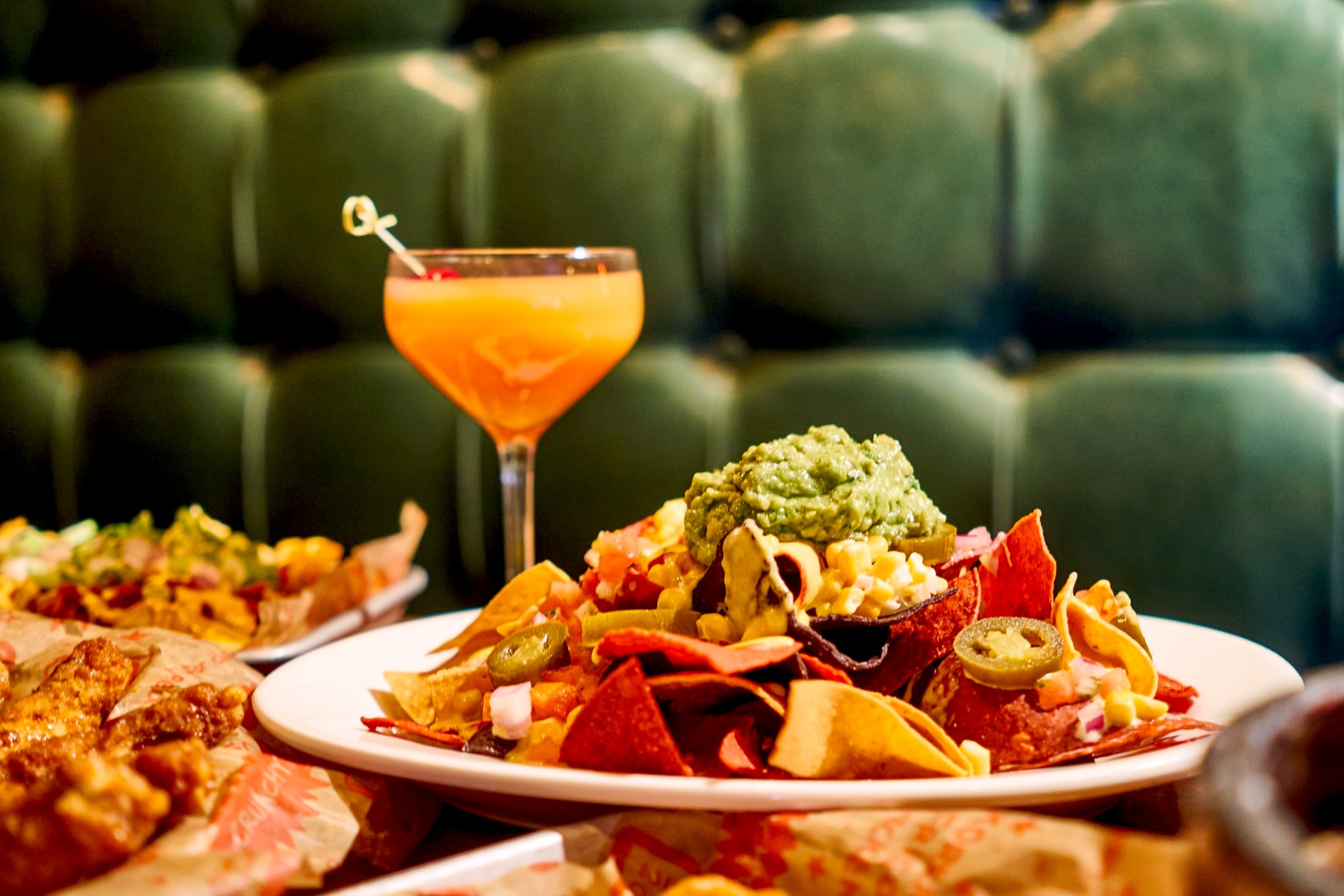 Nachos, wings and a cocktail at a Mad For Chicken booth